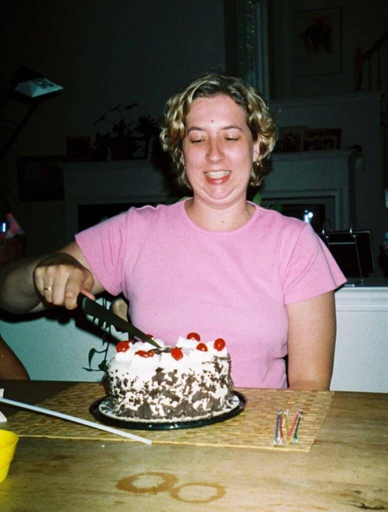 Bianca Johnson cutting cake during her twenties